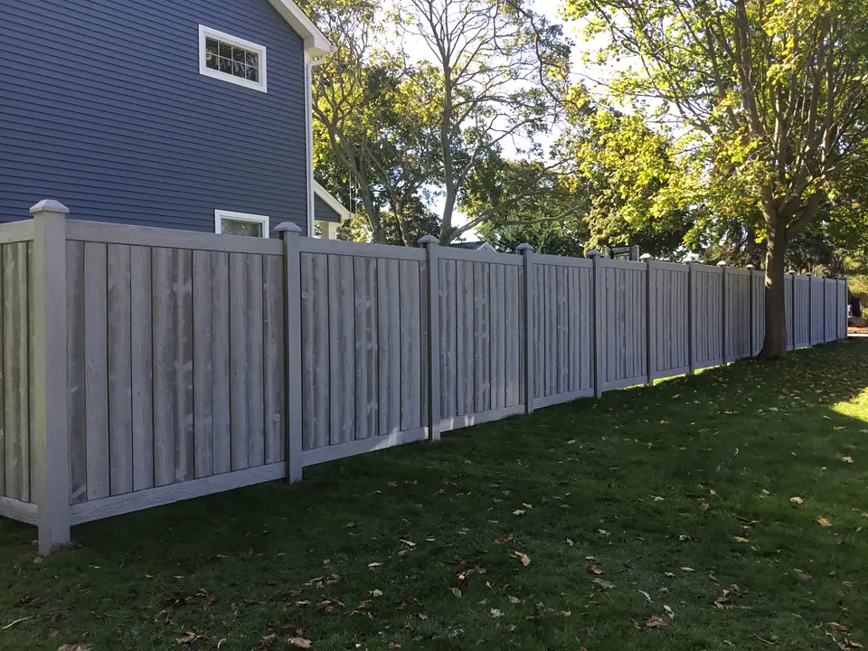 Long run of gray wood-look SimTek molded privacy fencing