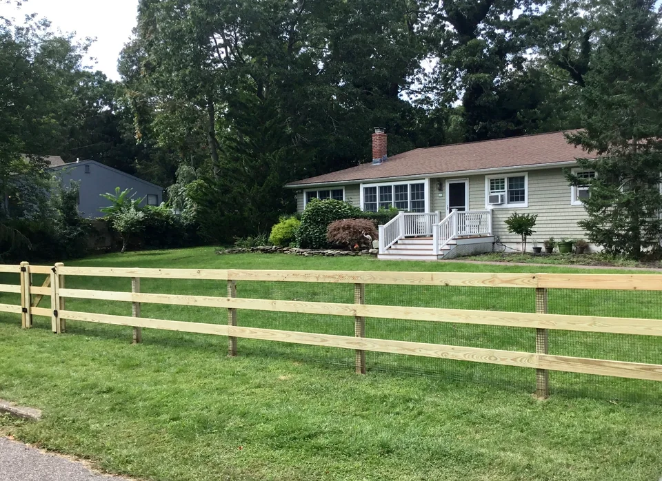Long run of three-rail board fencing in Speonk, New York.