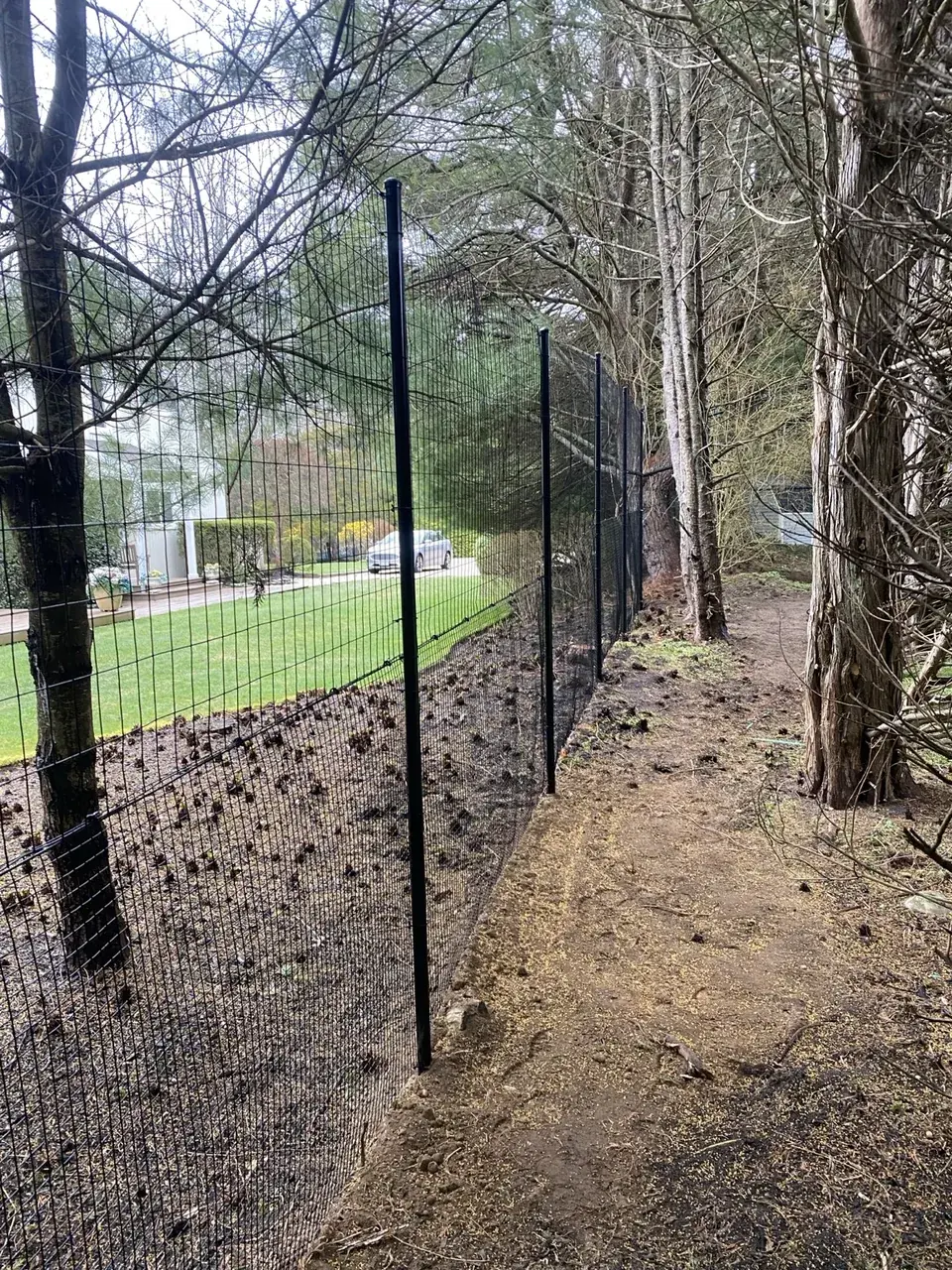 Stacked black deer fence showing tighter mesh on the lower section and larger wire above