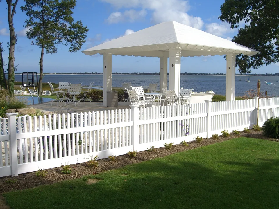 Three-foot white PVC picket fence in front of a waterfront infinity-pool setting in Centerport, New York