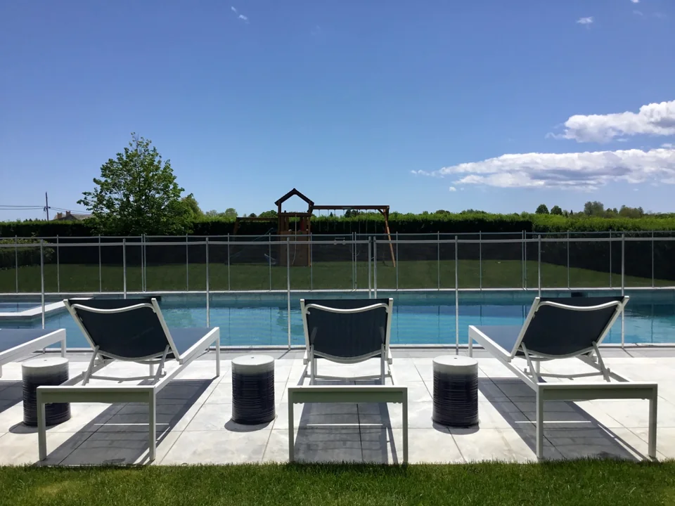 Transparent Guardian pool fence viewed through outdoor seating in Southampton