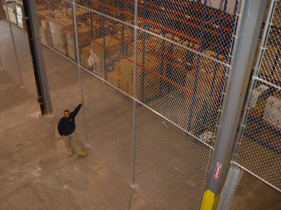 Twenty-foot-tall chain link warehouse enclosure built in stacked sections